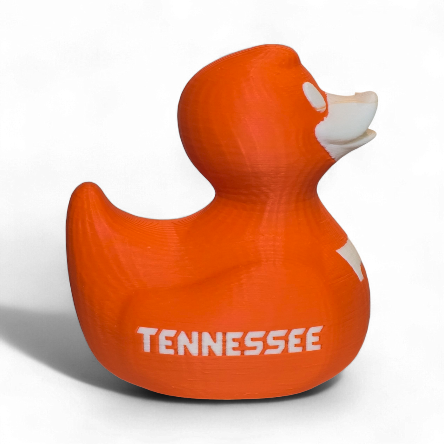 An orange 3D-printed PLA duck toy featuring the Tennessee Volunteers logo with a large white 'T' on the side and 'VOL' printed in white on the back, set against a plain white background.