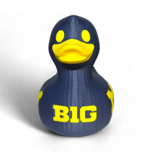 A 3D-printed PLA duck in navy blue with bright yellow accents, featuring the letters 'BIG' on the front, set against a plain white background.