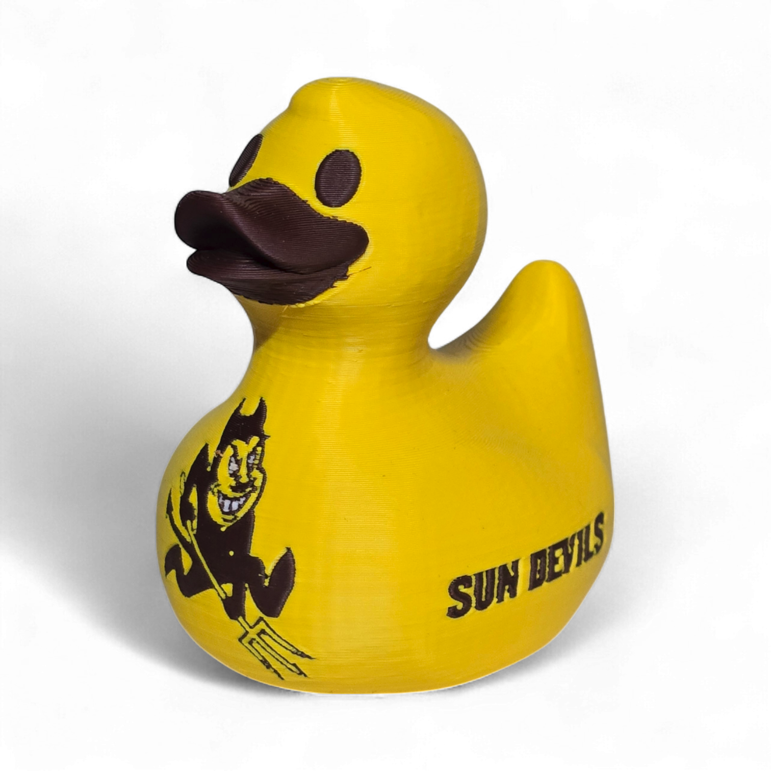A bright yellow 3D printed PLA duck featuring the black 'SUN DEVILS' text and a cartoon devil graphic on its side, set against a plain white background.