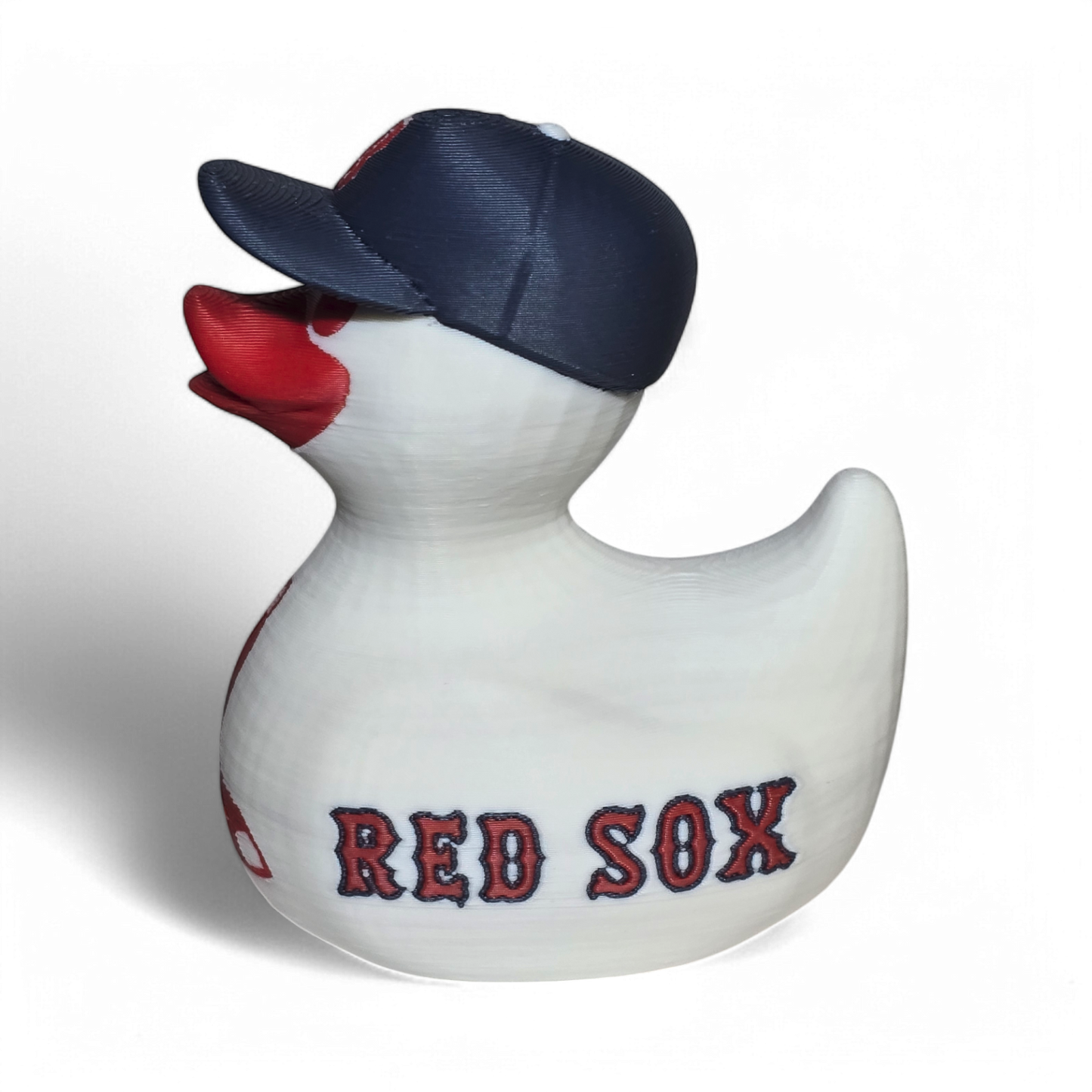 A white 3D printed PLA duck styled as a Boston Red Sox player, wearing a navy blue cap with a red 'B' logo and featuring red painted details and 'RED SOX' text on the side.