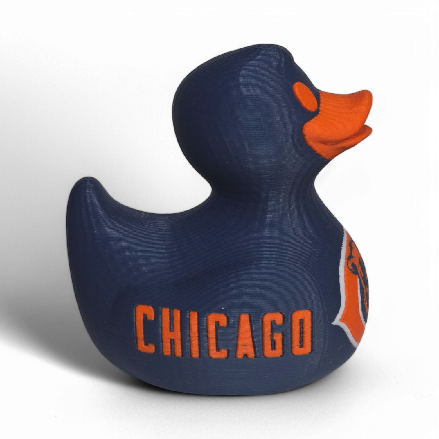 A navy blue 3D printed PLA duck with an orange beak and orange eye, featuring the Chicago Bears logo on the belly and the word 'BEARS' on the side, set against a plain white background.