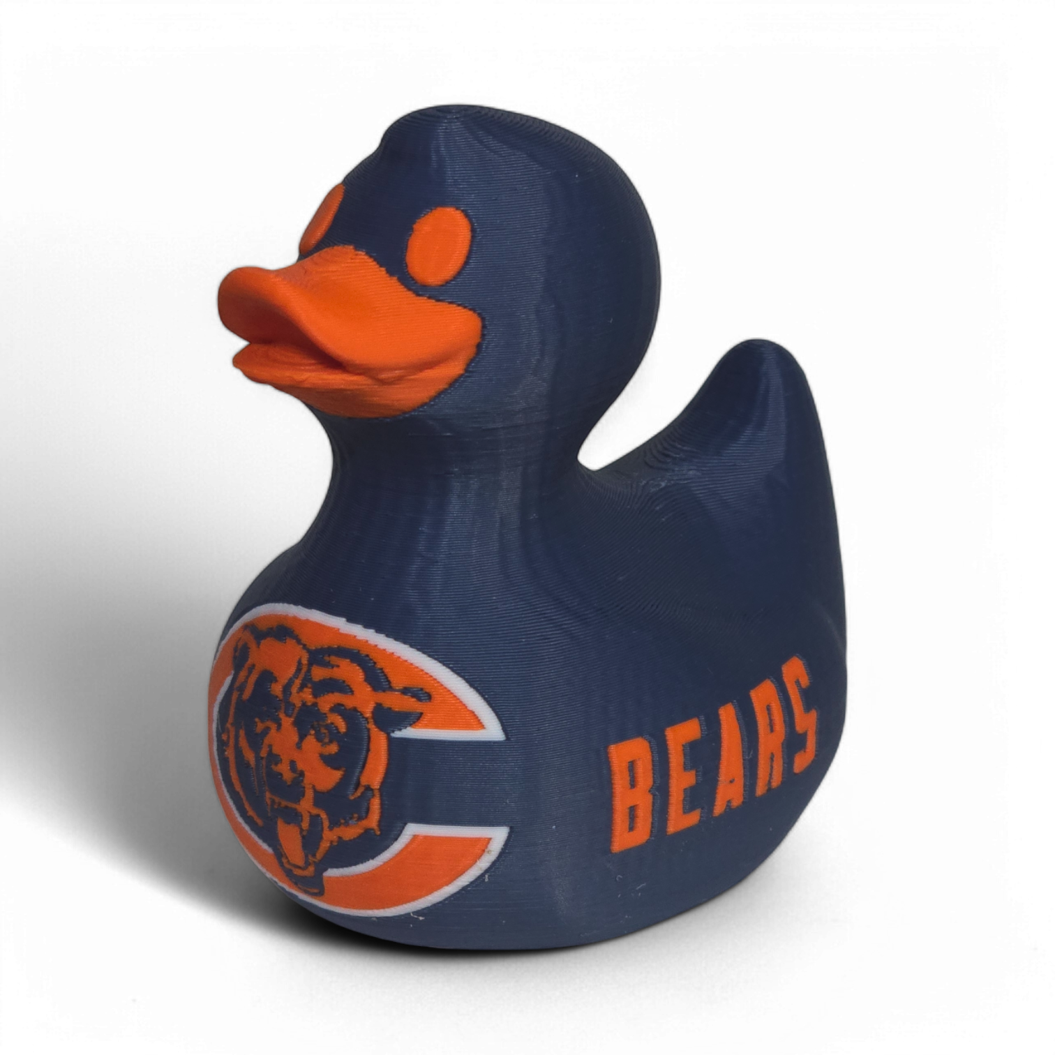 A navy blue 3D printed PLA duck with an orange beak and orange eye, featuring the Chicago Bears logo on the belly and the word 'BEARS' on the side, set against a plain white background.
