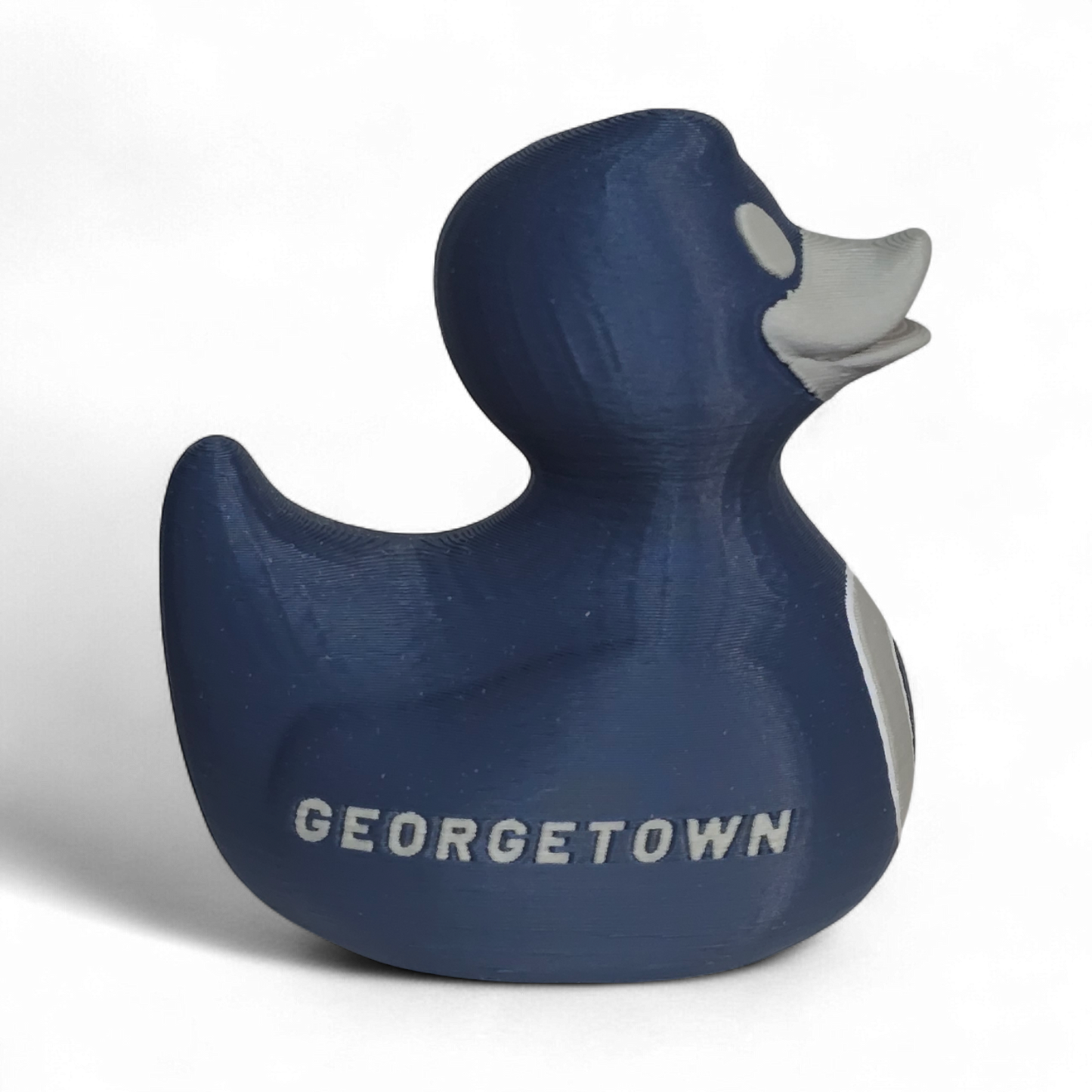 A dark blue 3D printed PLA duck toy featuring the white letters 'G' and 'HOYAS' on its side, with a gray beak and eye, set against a plain white background.