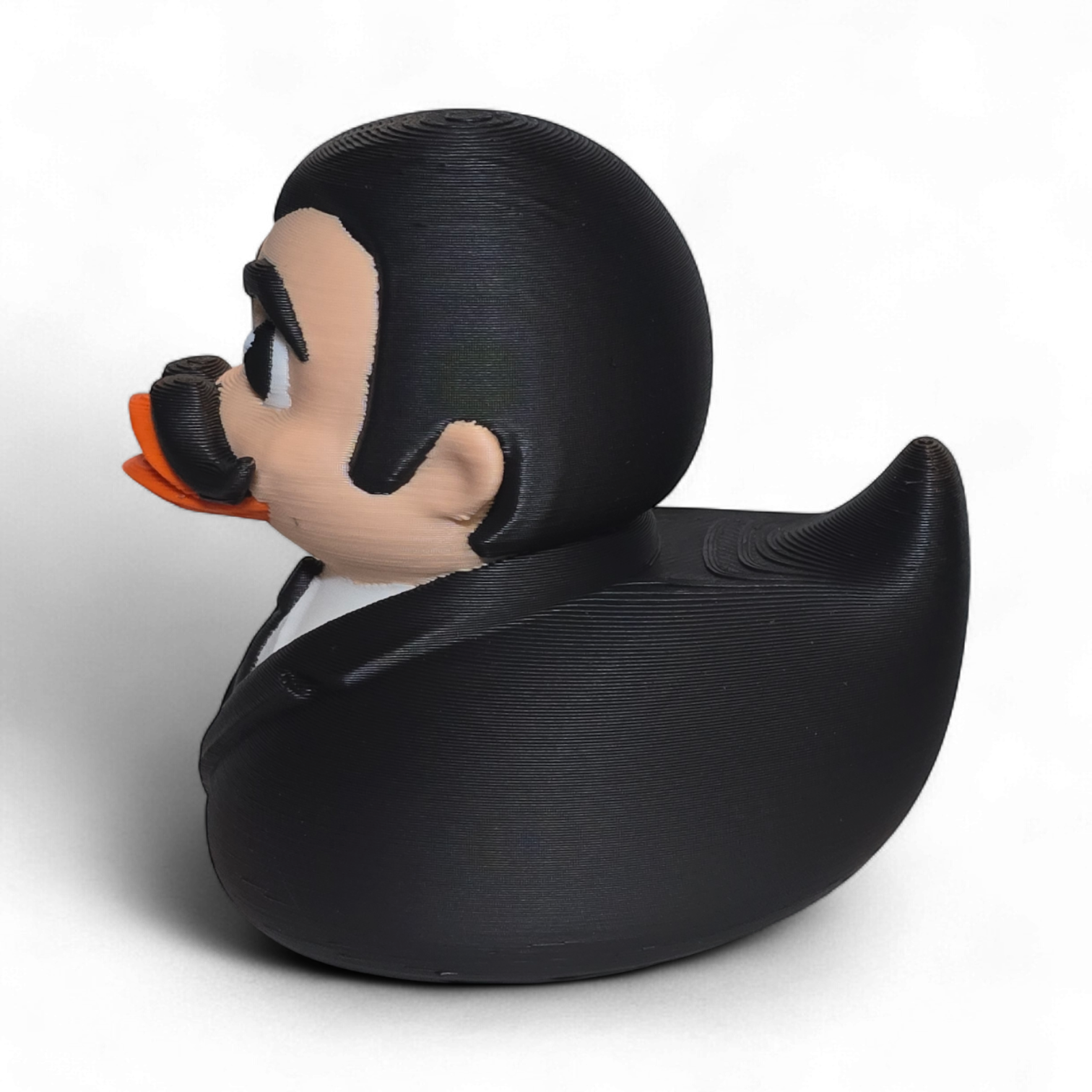 3D printed PLA duck with a formal outfit and mustache on a white background
