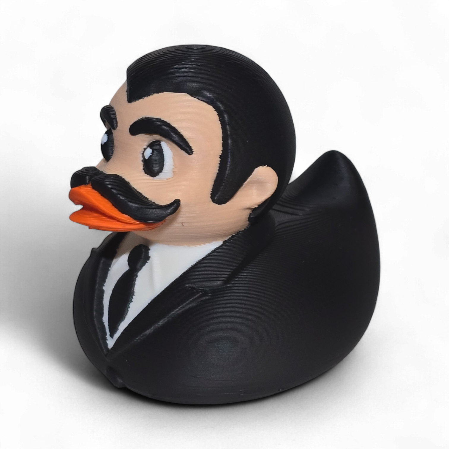 3D printed PLA duck with a formal outfit and mustache on a white background