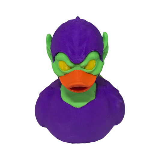 A 3D printed duck styled as the Marvel character Green Goblin, featuring a purple body and helmet, green skin, and an orange beak, isolated on a white background.