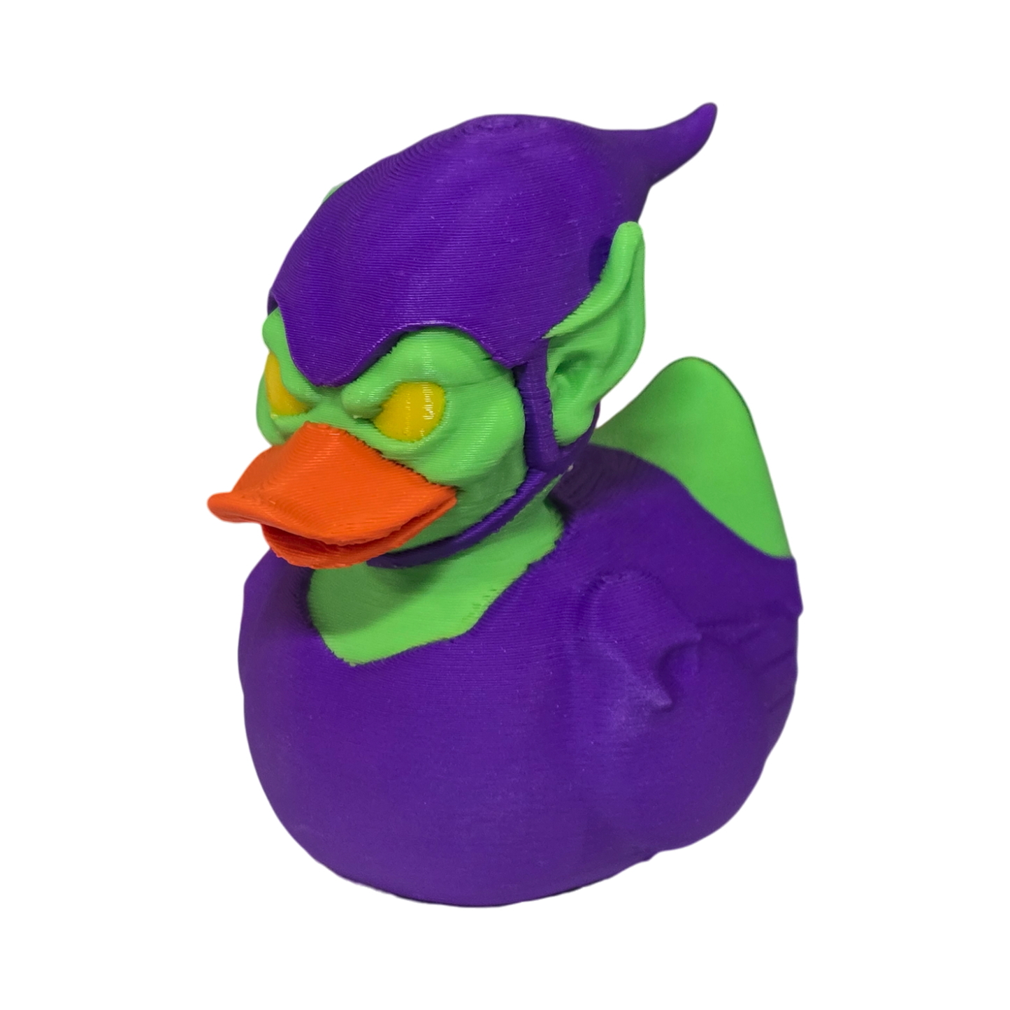 A 3D printed duck styled as the Marvel character Green Goblin, featuring a purple body and helmet, green skin, and an orange beak, isolated on a white background.