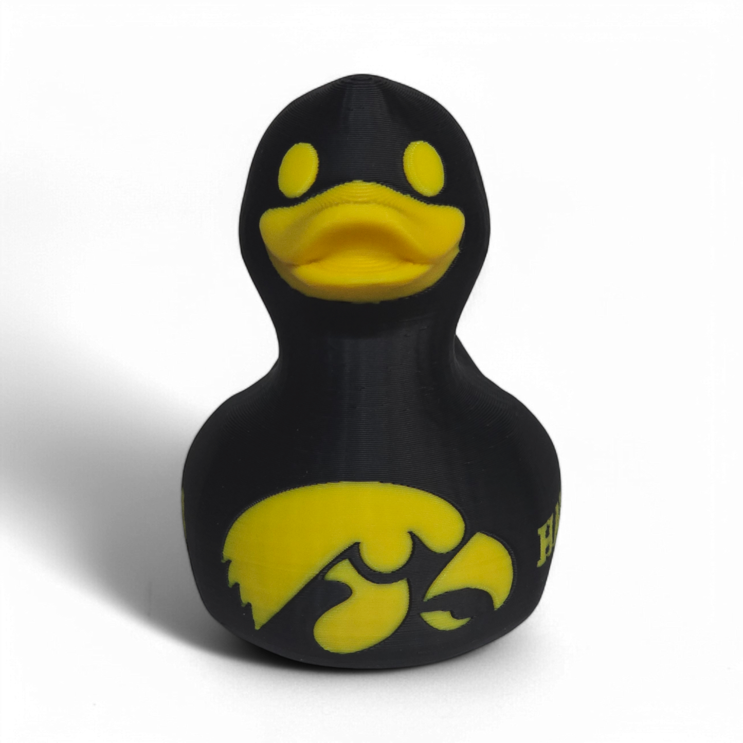 A black 3D Printed PLA duck with yellow accents, featuring the Iowa Hawkeyes logo and the word 'HAWKEYES' on its side, set against a plain white background.