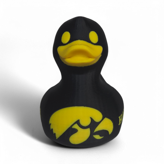 A black 3D Printed PLA duck with yellow accents, featuring the Iowa Hawkeyes logo and the word 'HAWKEYES' on its side, set against a plain white background.