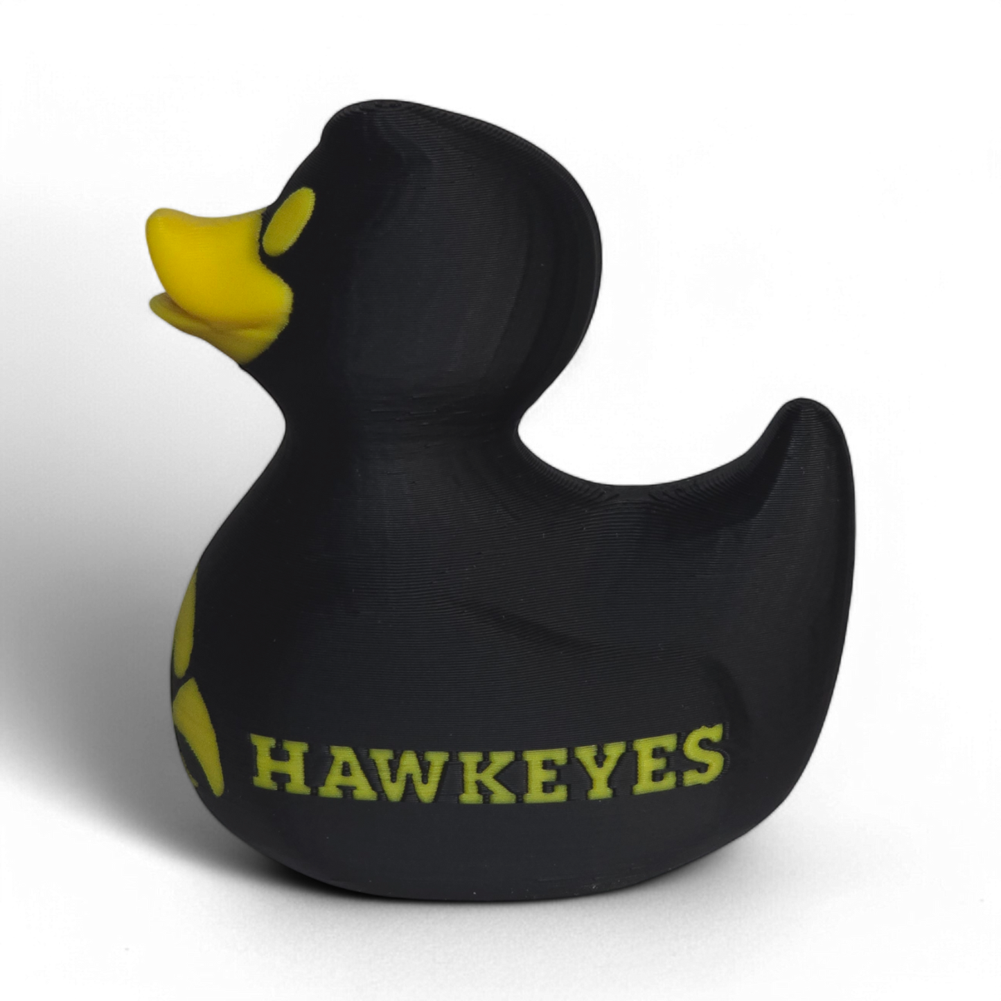 A black 3D Printed PLA duck with yellow accents, featuring the Iowa Hawkeyes logo and the word 'HAWKEYES' on its side, set against a plain white background.