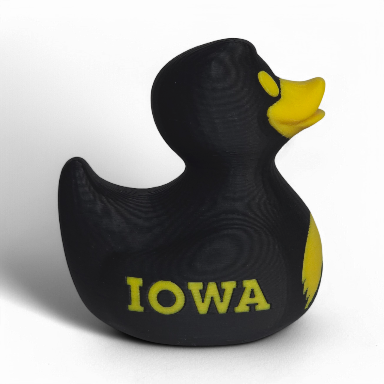 A black 3D printed PLA duck with a yellow beak, yellow eye, and yellow 'IOWA' lettering on the side, shown against a plain white background.