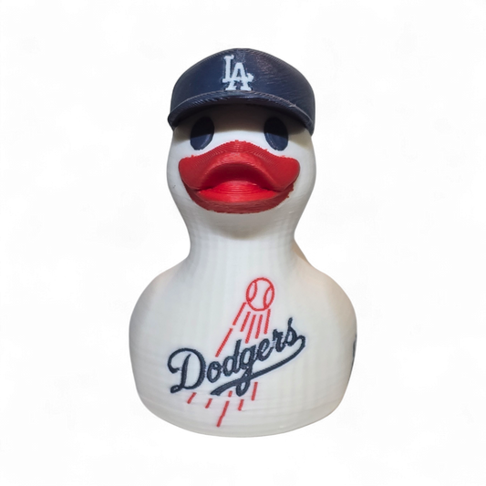 A white 3D printed PLA duck styled as a Los Angeles Dodgers player, featuring a navy blue cap with a white 'LA' logo, a red beak, and navy and red 'Dodgers' and 'ANGELES' graphics on its body, set against a plain white background.