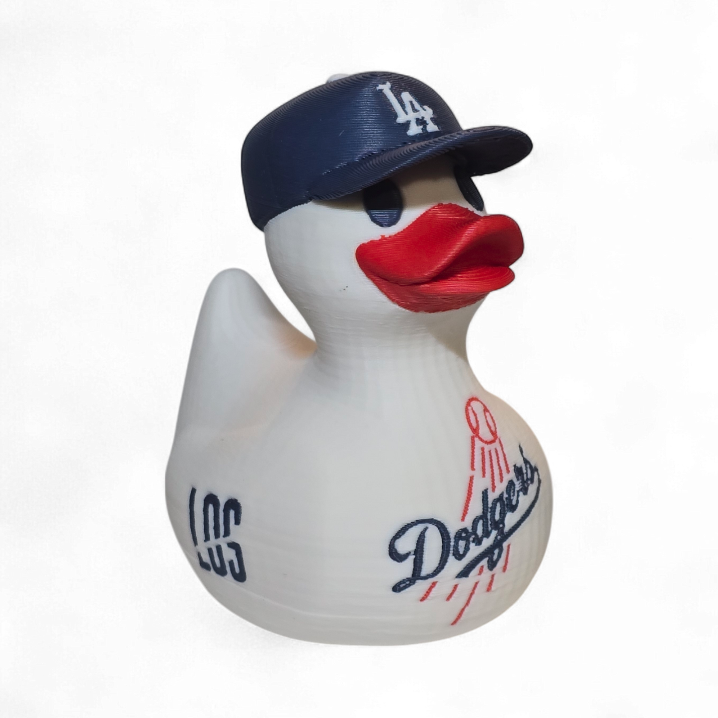 A white 3D printed PLA duck styled as a Los Angeles Dodgers player, featuring a navy blue cap with a white 'LA' logo, a red beak, and navy and red 'Dodgers' and 'ANGELES' graphics on its body, set against a plain white background.