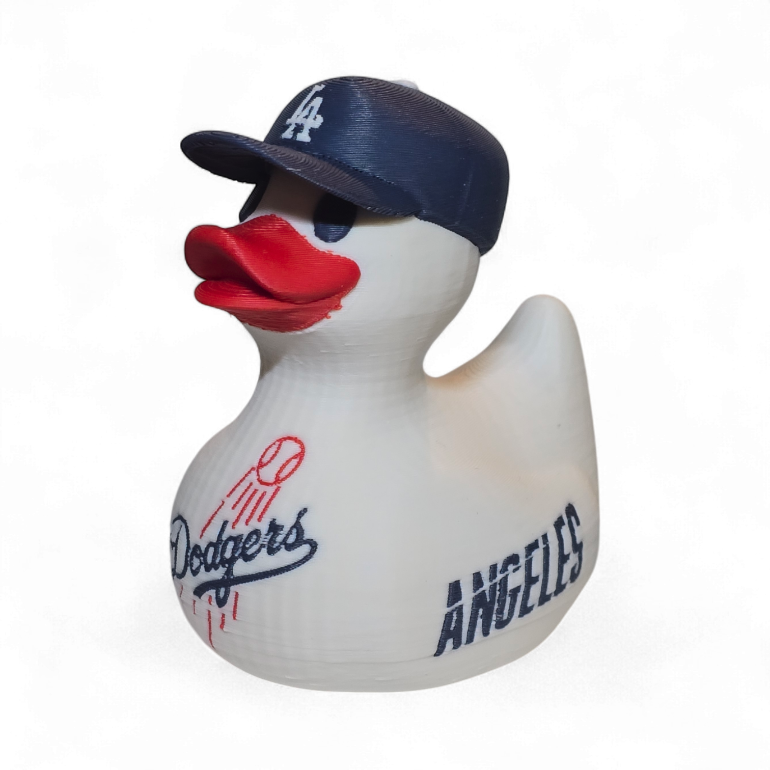 A white 3D printed PLA duck styled as a Los Angeles Dodgers player, featuring a navy blue cap with a white 'LA' logo, a red beak, and navy and red 'Dodgers' and 'ANGELES' graphics on its body, set against a plain white background.