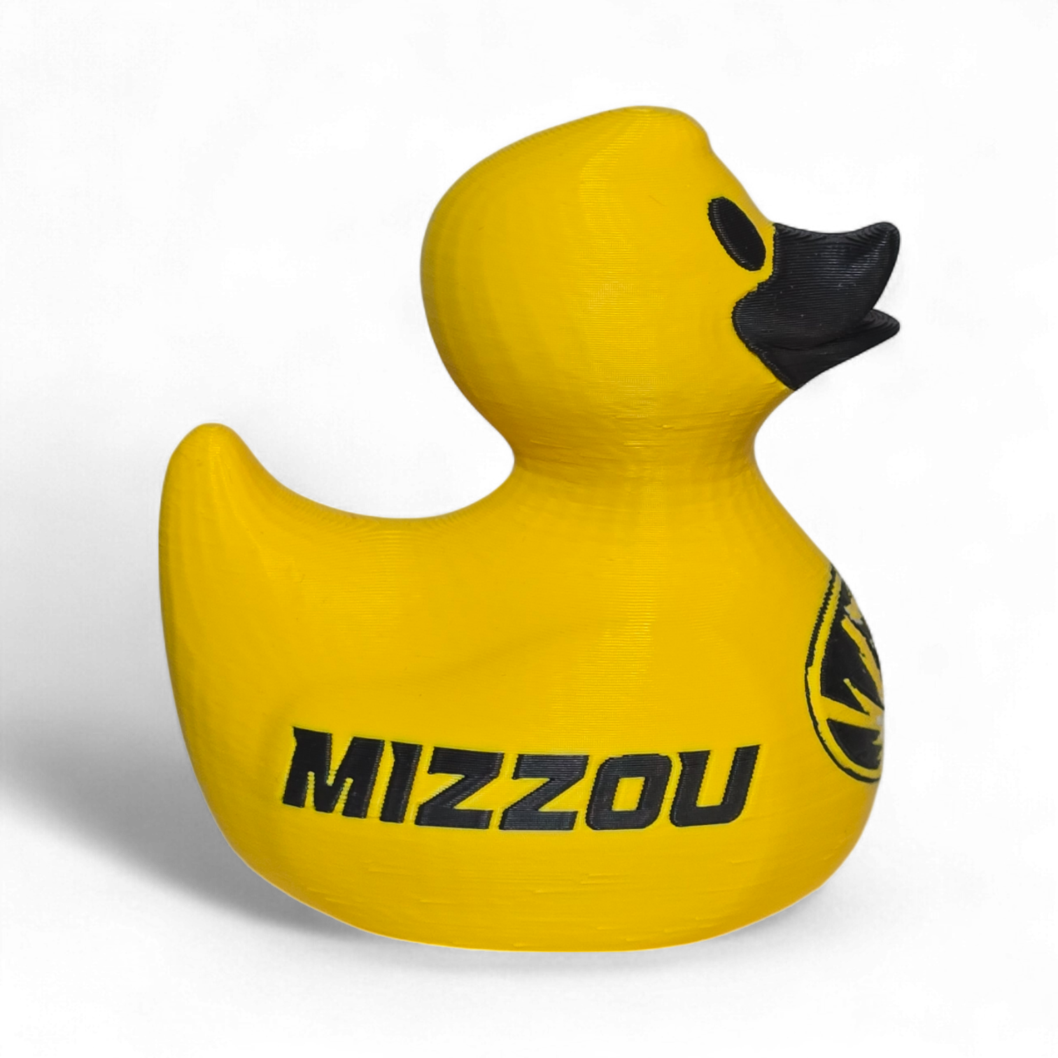 A bright yellow 3D Printer PLA duck with a black beak and black printed graphics, including a tiger logo and the word 'TIGERS' on the side, shown on a plain white background.