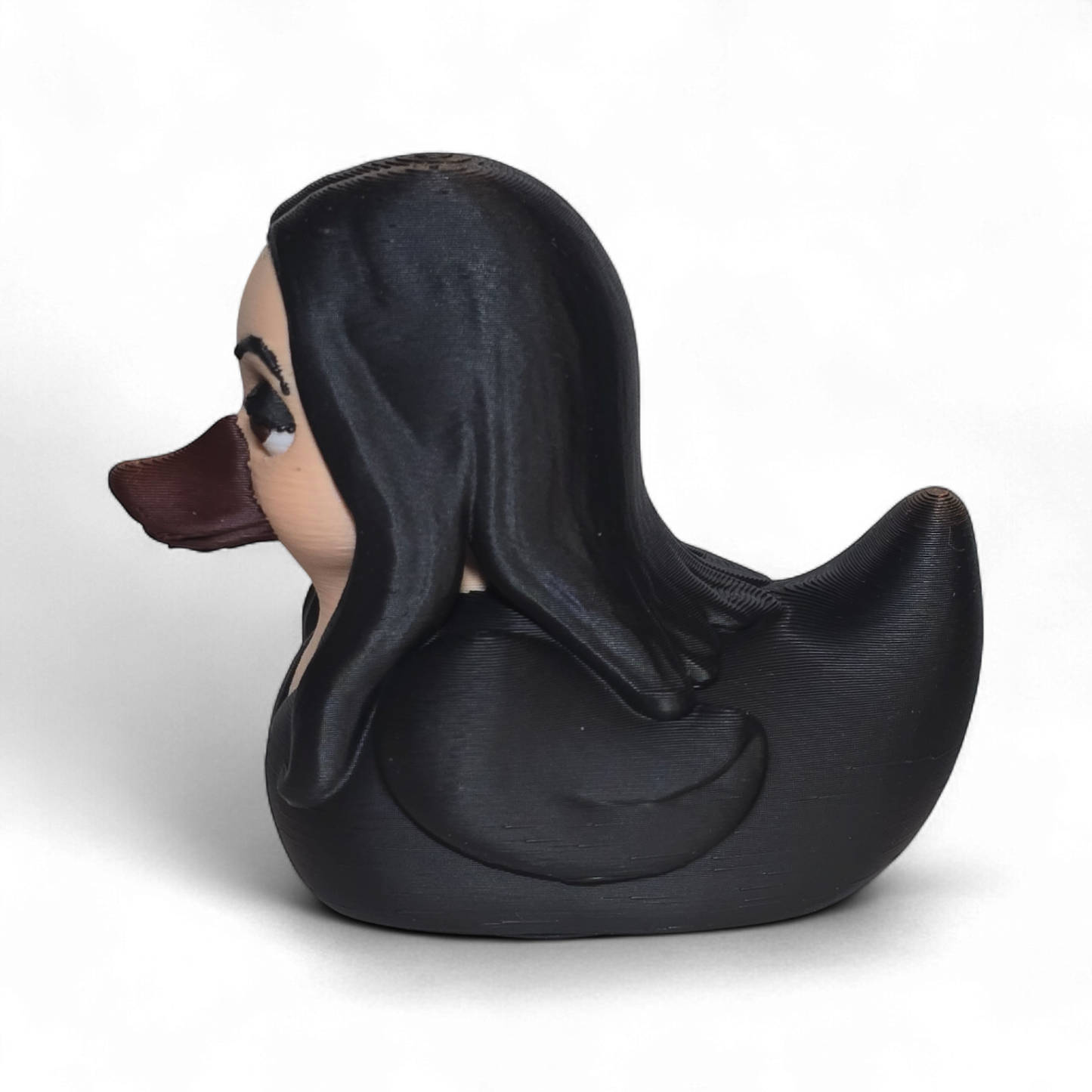 A novelty 3D printed PLA duck styled as a woman with long black hair, a beige face, and a dark brown beak, shown on a plain white background.