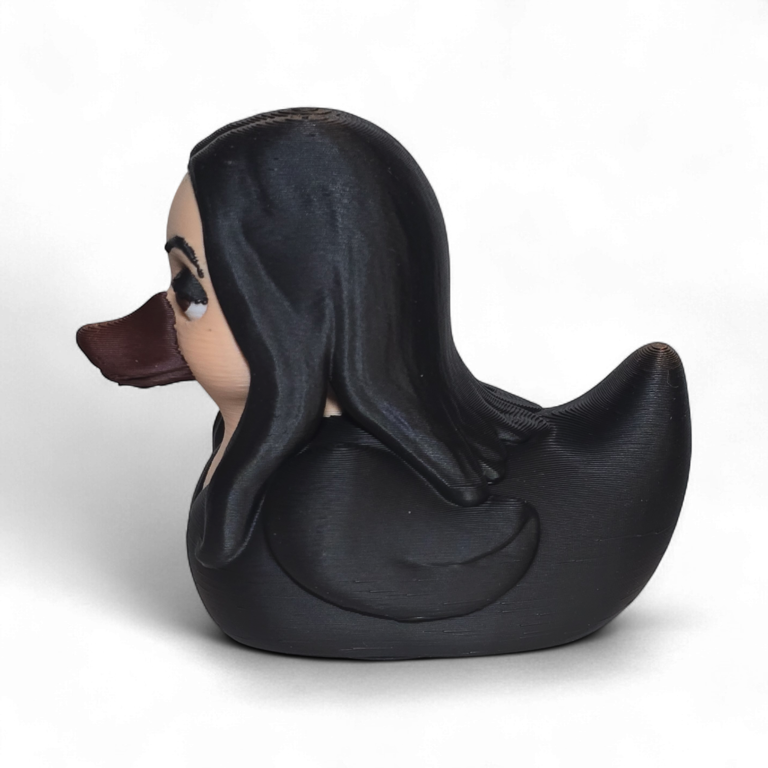 A novelty 3D printed PLA duck styled as a woman with long black hair, a beige face, and a dark brown beak, shown on a plain white background.