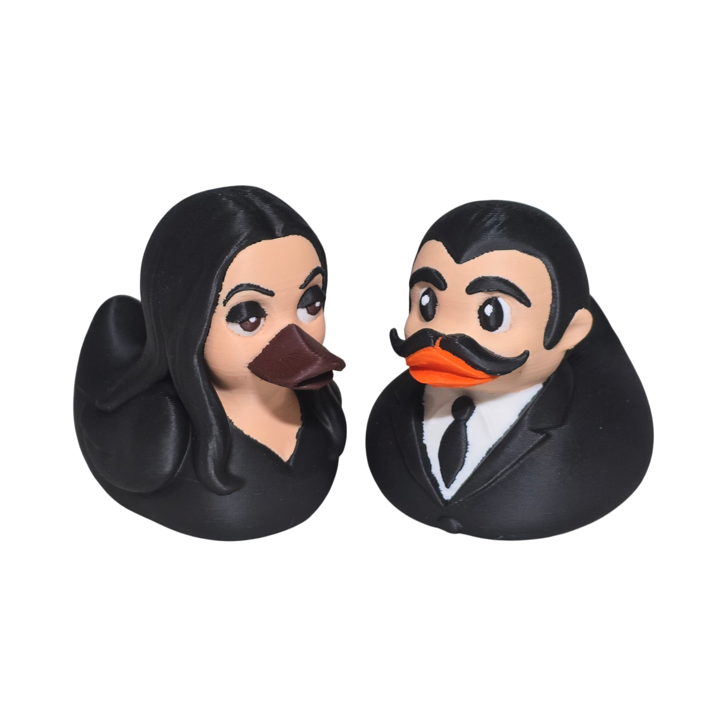 Two 3D printed PLA duck figures, one with long hair and the other with a mustache, on a white background.