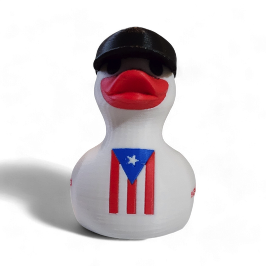 A white 3D printed duck wearing a black baseball cap with a white New Era logo, featuring a red beak and a Puerto Rico flag graphic on its side, with the red text '¡BENDITO' printed on the front.