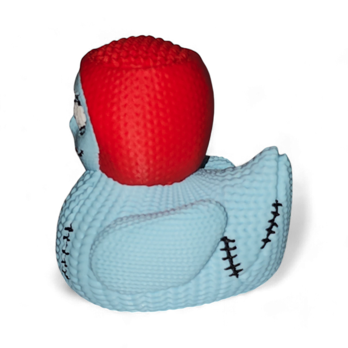 A 3D Printed PLA duck, featuring a light blue body with black spots and a stitched seam, topped with a bright red textured head resembling hair, and detailed with cartoon eyes and a smile.
