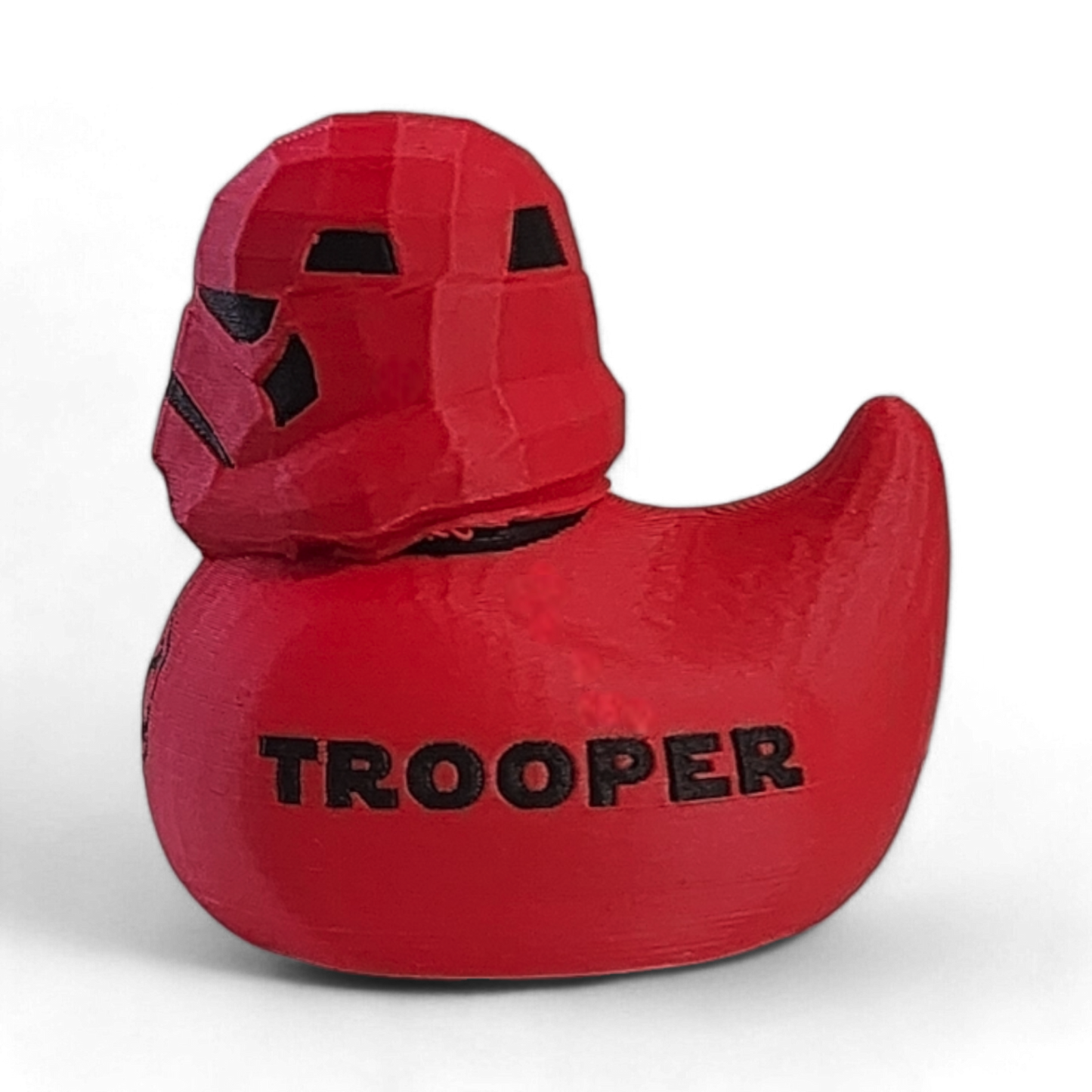 Red 'Trooper' duck toy with helmet on a white background