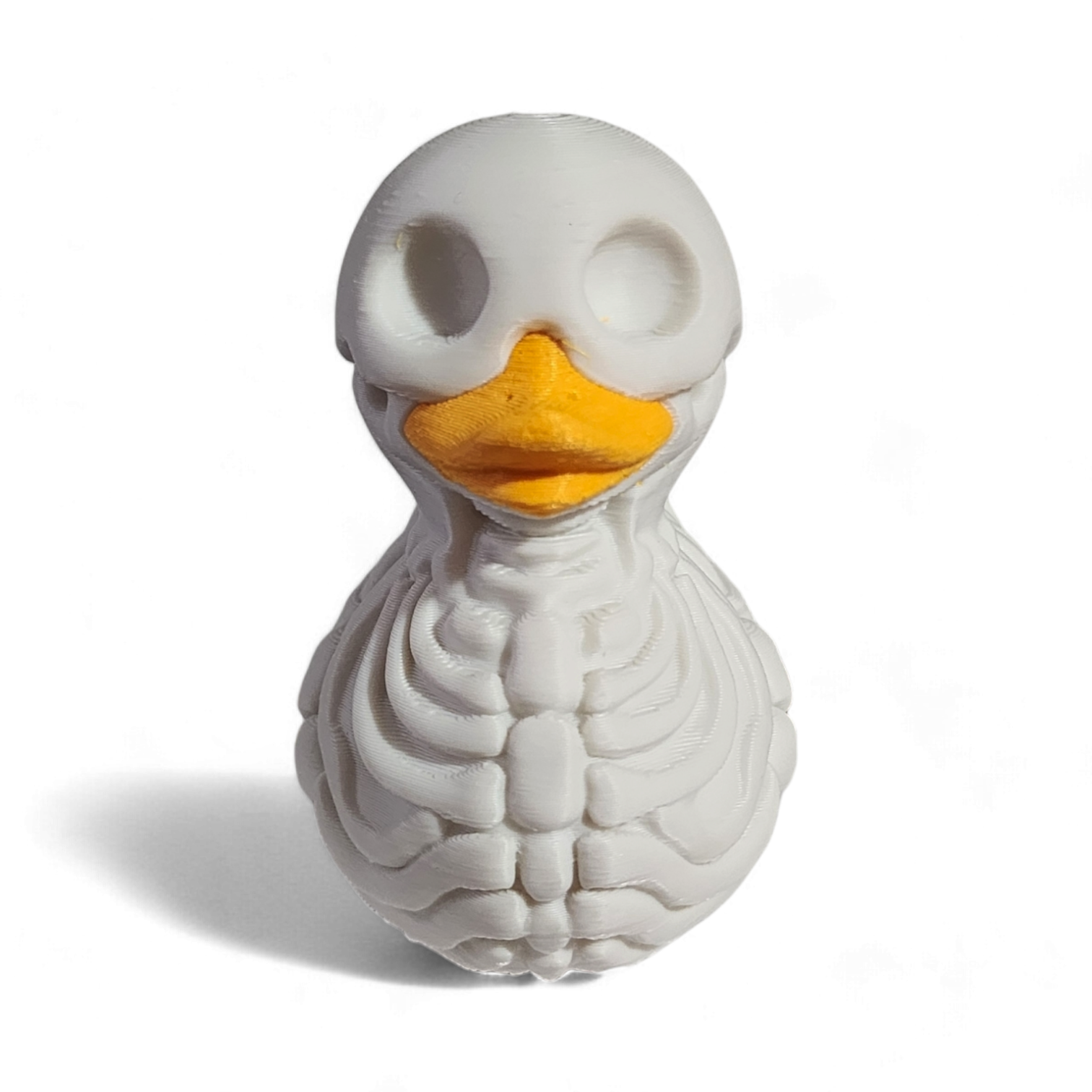 A white 3D printed PLA duck styled as a skeleton, featuring a hollowed-out head, exposed rib details, and a bright yellow beak, shown on a white background with a soft shadow.