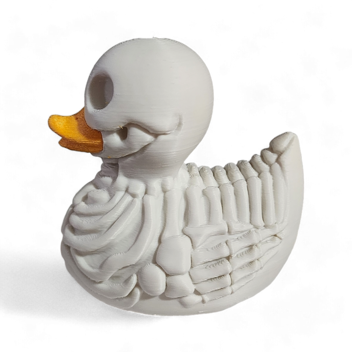 A white 3D printed PLA duck styled as a skeleton, featuring a hollowed-out head, exposed rib details, and a bright yellow beak, shown on a white background with a soft shadow.