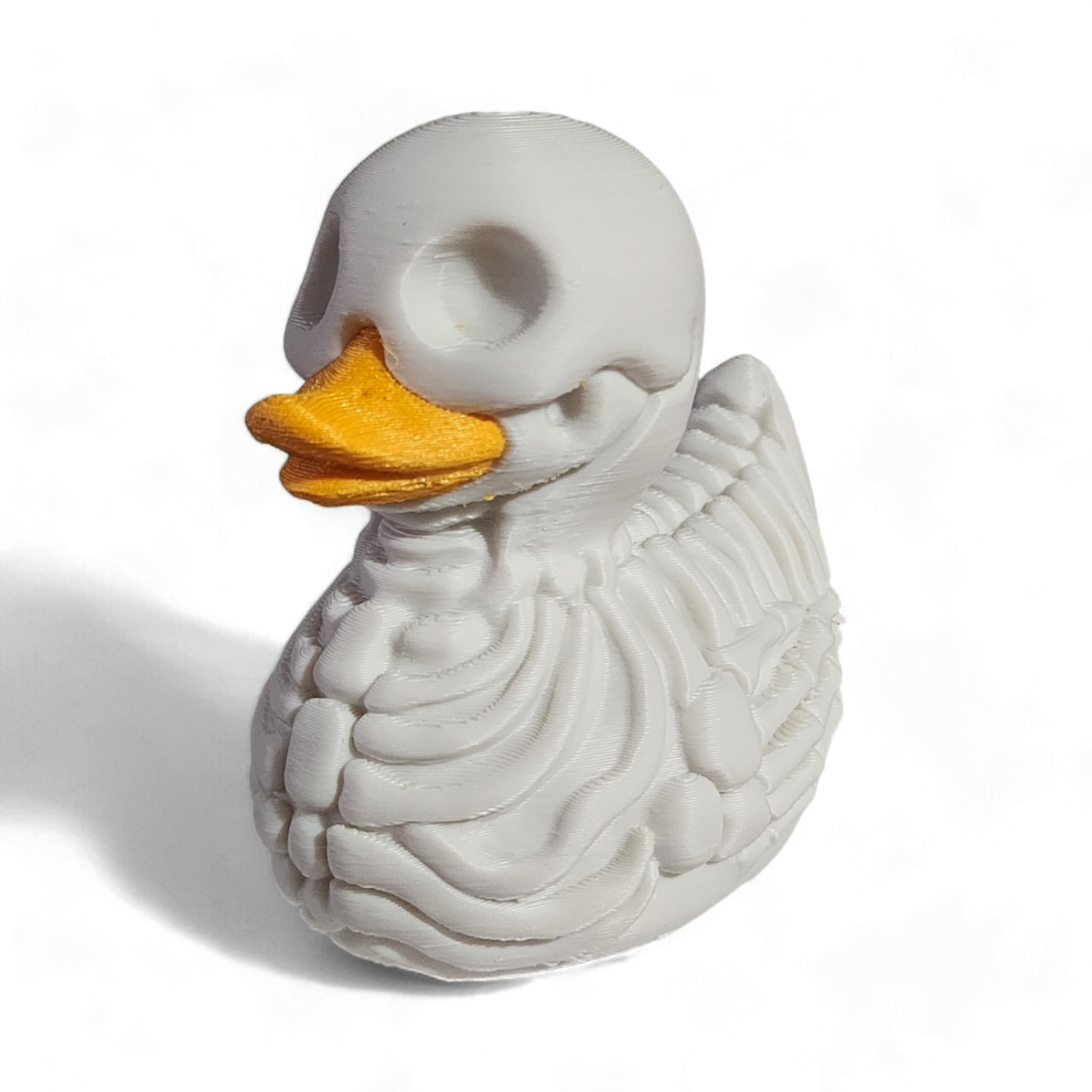 A white 3D printed PLA duck styled as a skeleton, featuring a hollowed-out head, exposed rib details, and a bright yellow beak, shown on a white background with a soft shadow.
