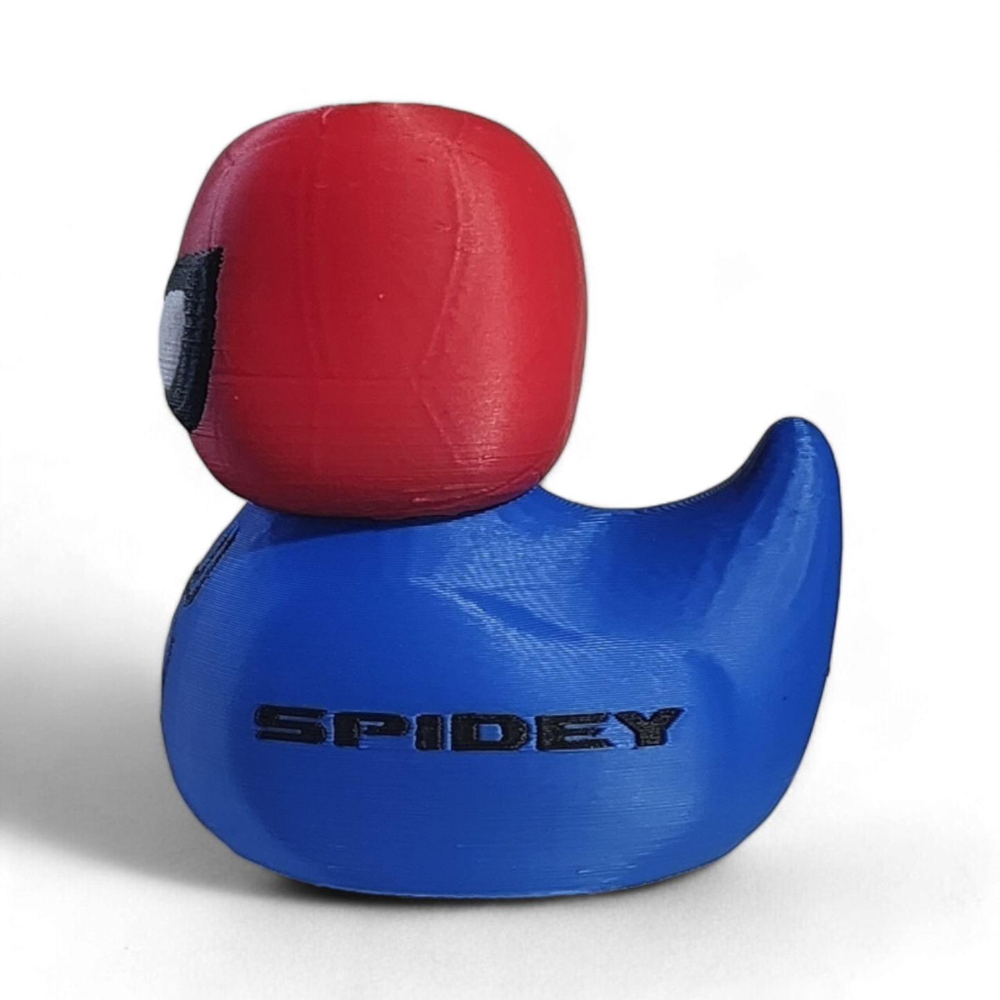 A Spider-Man-themed 3D printed PLA duck, featuring a red head with black and white eyes and a blue body with a black spider emblem and the word 'SPIDEY' printed on it, set against a plain white background.