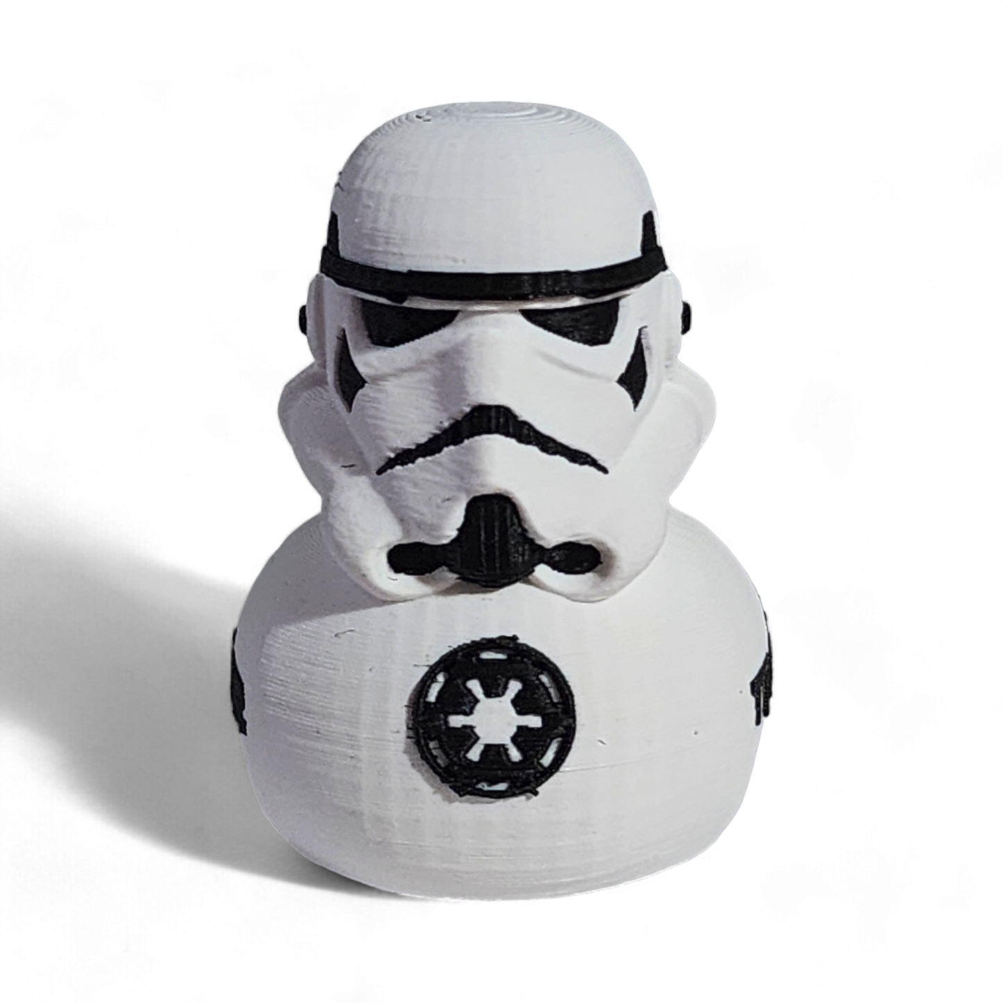 A white 3D printed PLA duck shaped like a Stormtrooper helmet, with black printed details including the Imperial crest and the word 'TROOPER' on the side, shown on a white background.