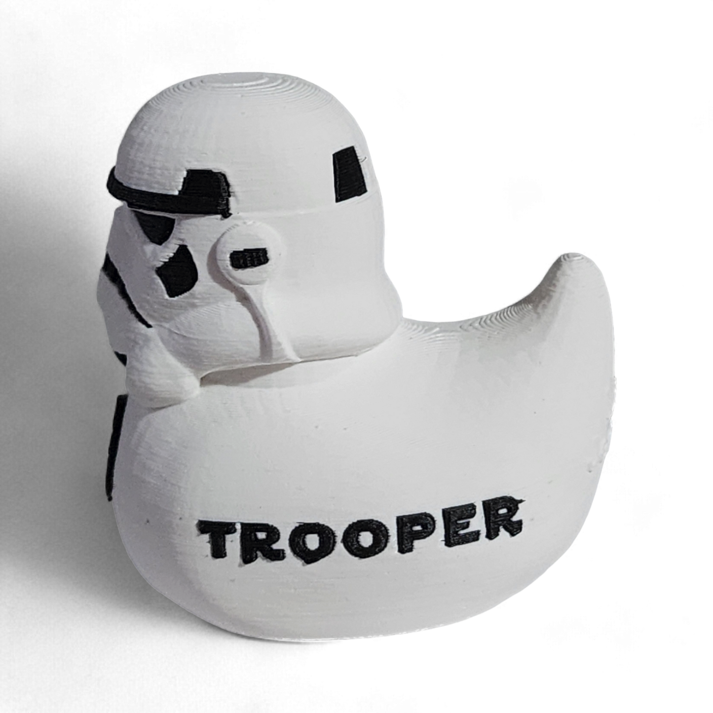 A white 3D printed PLA duck shaped like a Stormtrooper helmet, with black printed details including the Imperial crest and the word 'TROOPER' on the side, shown on a white background.