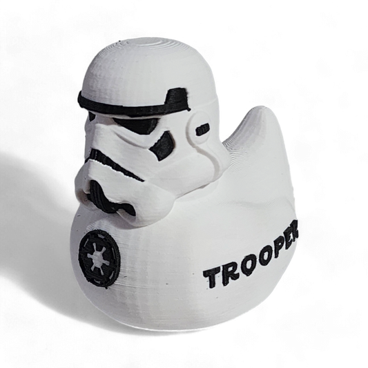 A white 3D printed PLA duck shaped like a Stormtrooper helmet, with black printed details including the Imperial crest and the word 'TROOPER' on the side, shown on a white background.
