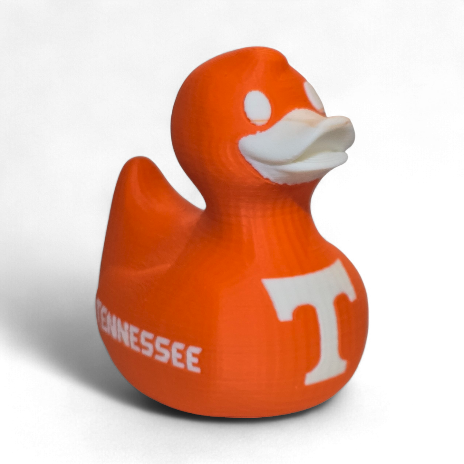 An orange 3D-printed PLA duck toy featuring the Tennessee Volunteers logo with a large white 'T' on the side and 'VOL' printed in white on the back, set against a plain white background.