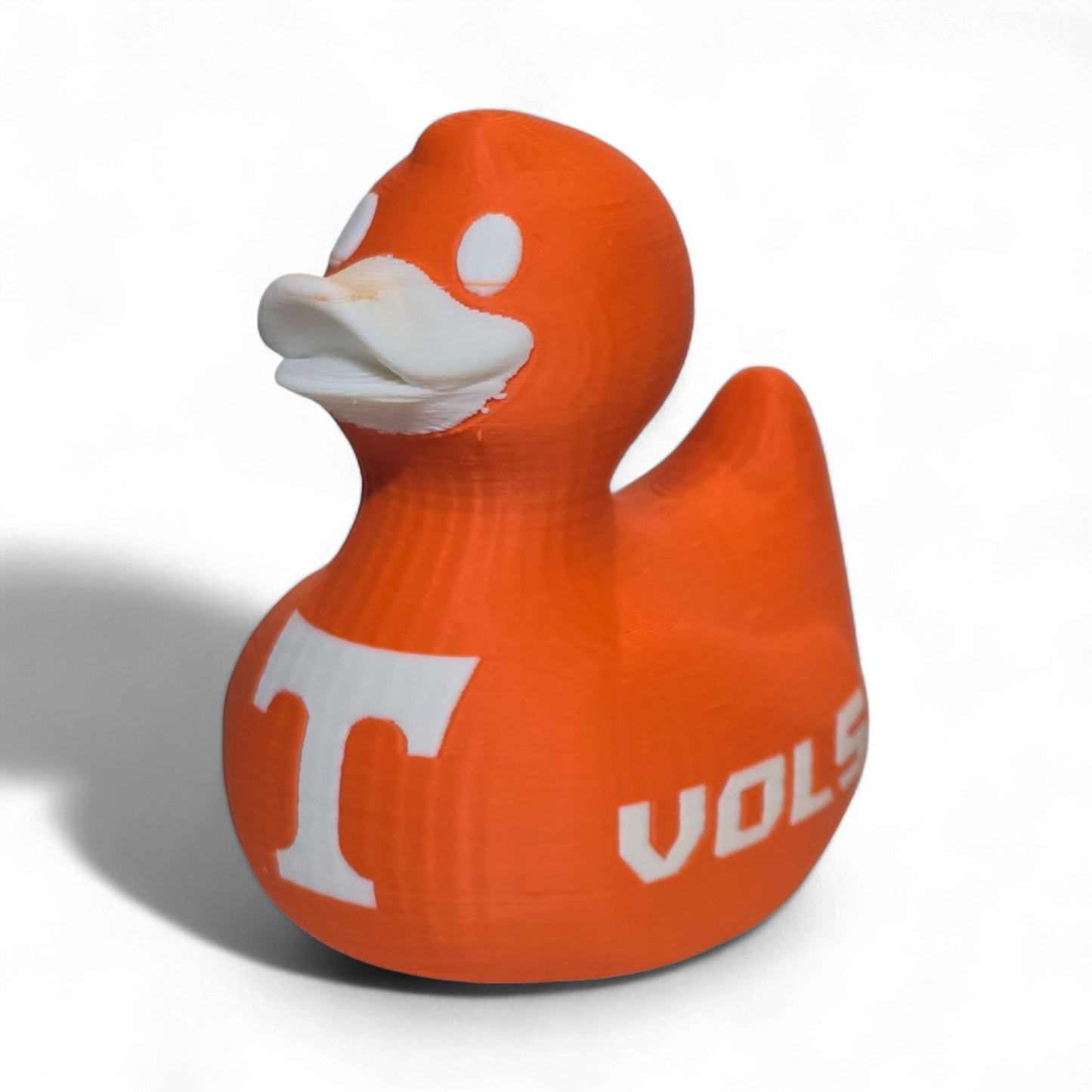 An orange 3D-printed PLA duck toy featuring the Tennessee Volunteers logo with a large white 'T' on the side and 'VOL' printed in white on the back, set against a plain white background.