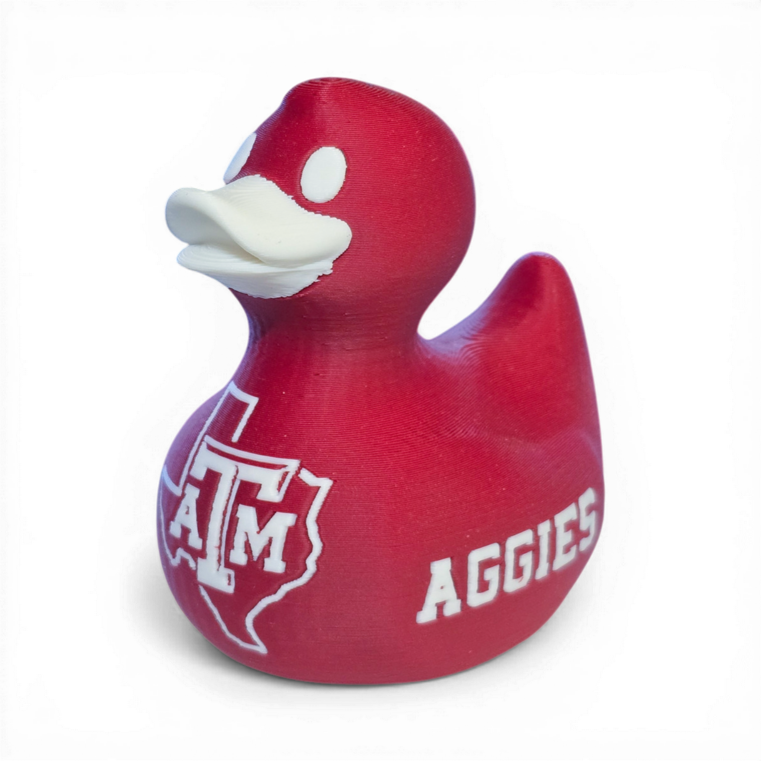 Red 3D printed PLA duck with Texas A&M logo on a white background