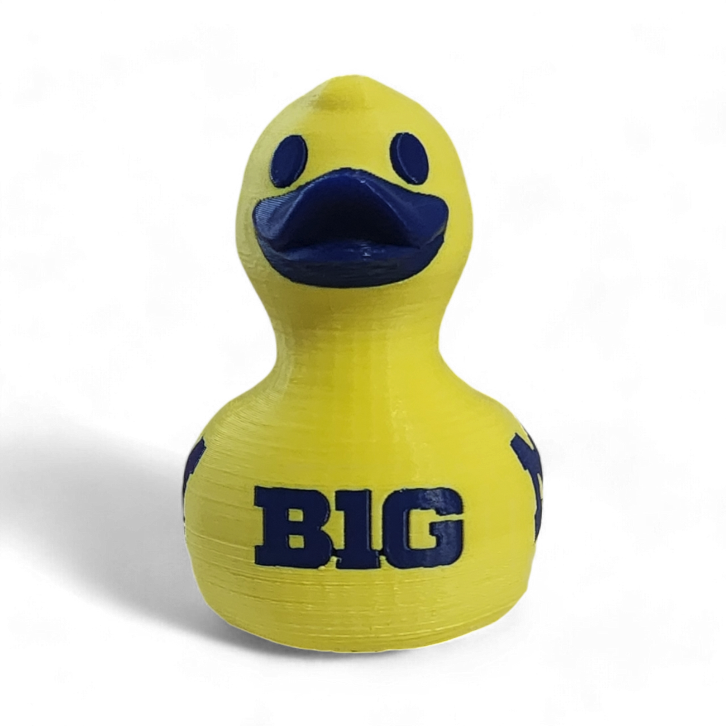 A yellow 3D printed duck with a dark blue beak, eyes, and the letters 'BIG' printed on the front, shown against a plain white background.