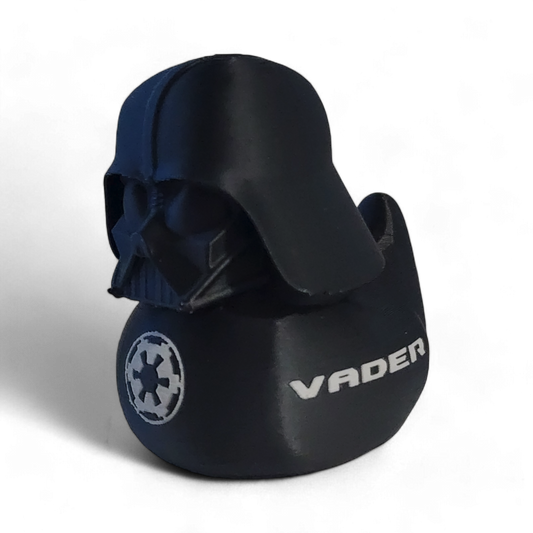 A Darth Vader themed helmet-shaped 3D printed PLA duck , featuring the white Star Wars VADER logo and an Imperial crest on the side, set against a plain white background.