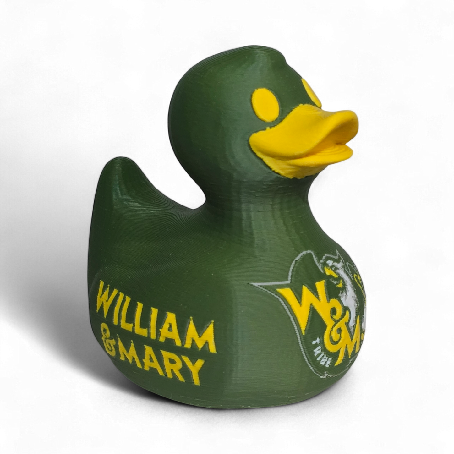 A green 3D Printed PLA duck with a yellow beak and yellow eye, featuring a white and yellow W&M Tribe logo on the side, set against a plain white background.