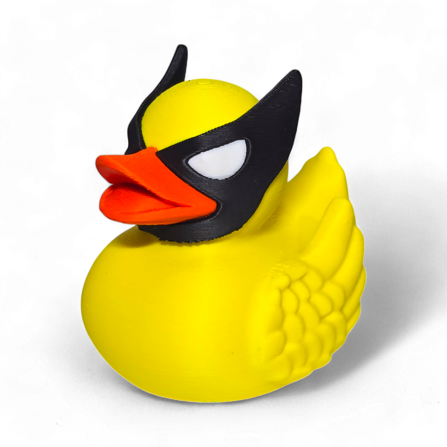 A small Wolverine figurine or toy in a bright yellow costume with black mask, blue accents, and white claws, photographed on a plain white background.