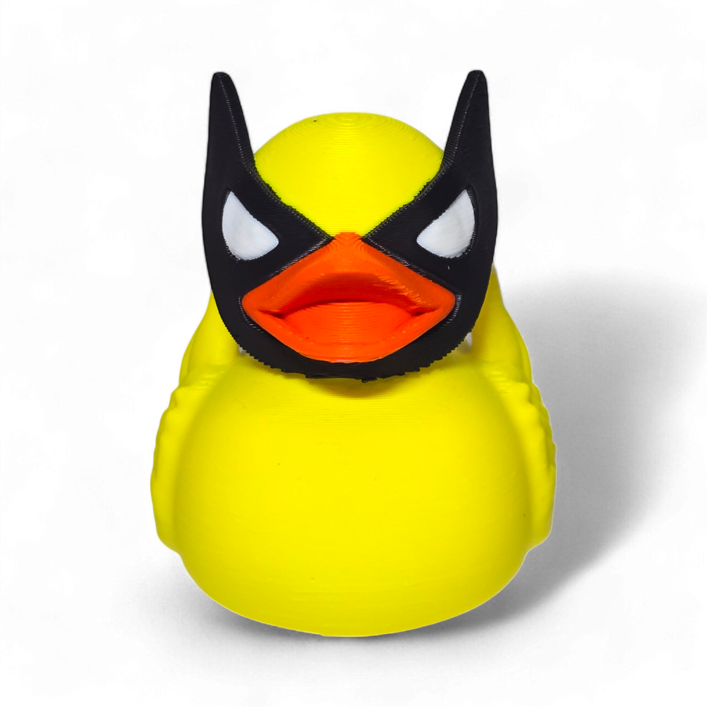 A small Wolverine figurine or toy in a bright yellow costume with black mask, blue accents, and white claws, photographed on a plain white background.