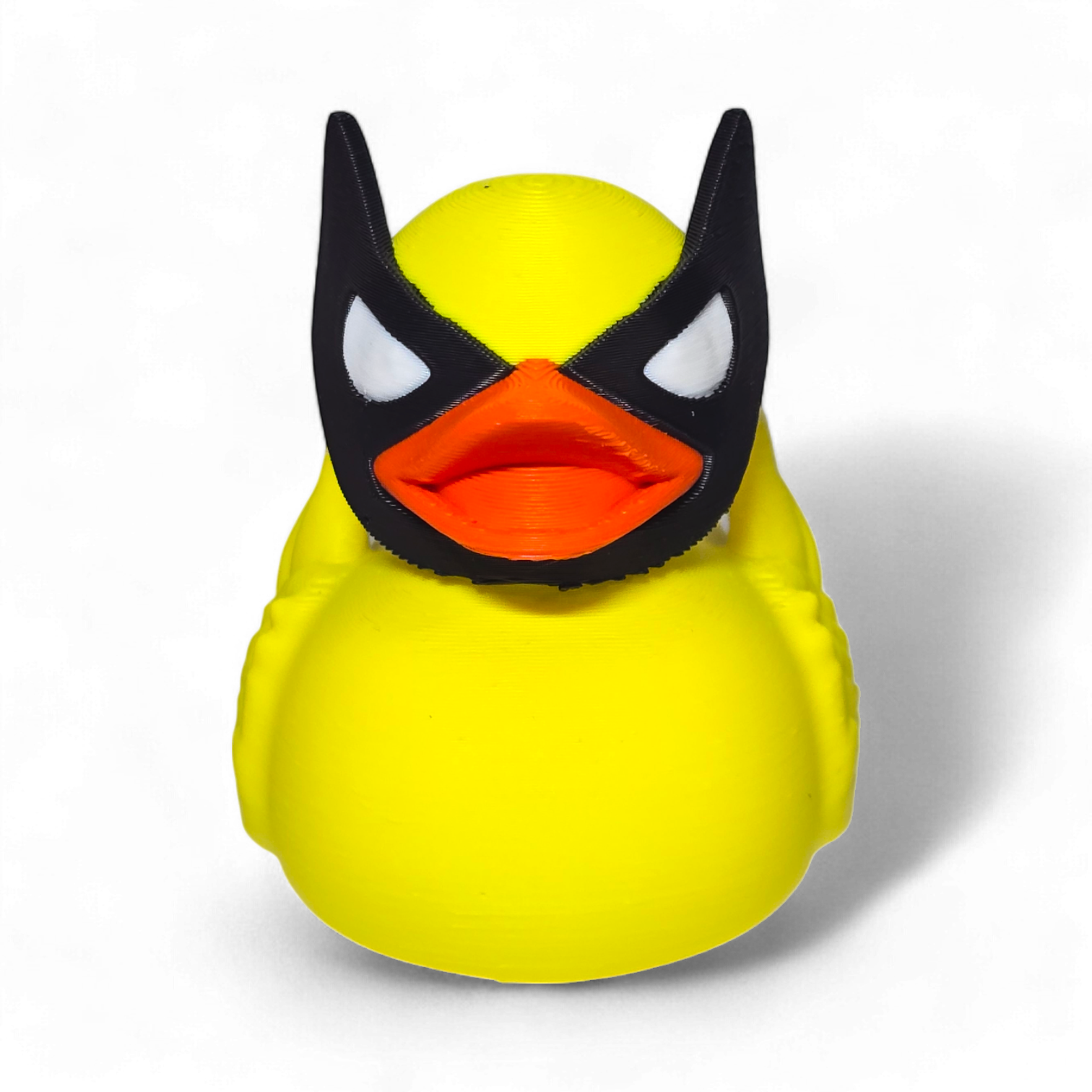 A small Wolverine figurine or toy in a bright yellow costume with black mask, blue accents, and white claws, photographed on a plain white background.