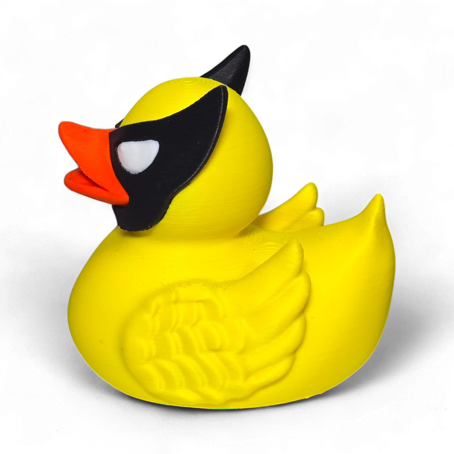 A small Wolverine figurine or toy in a bright yellow costume with black mask, blue accents, and white claws, photographed on a plain white background.