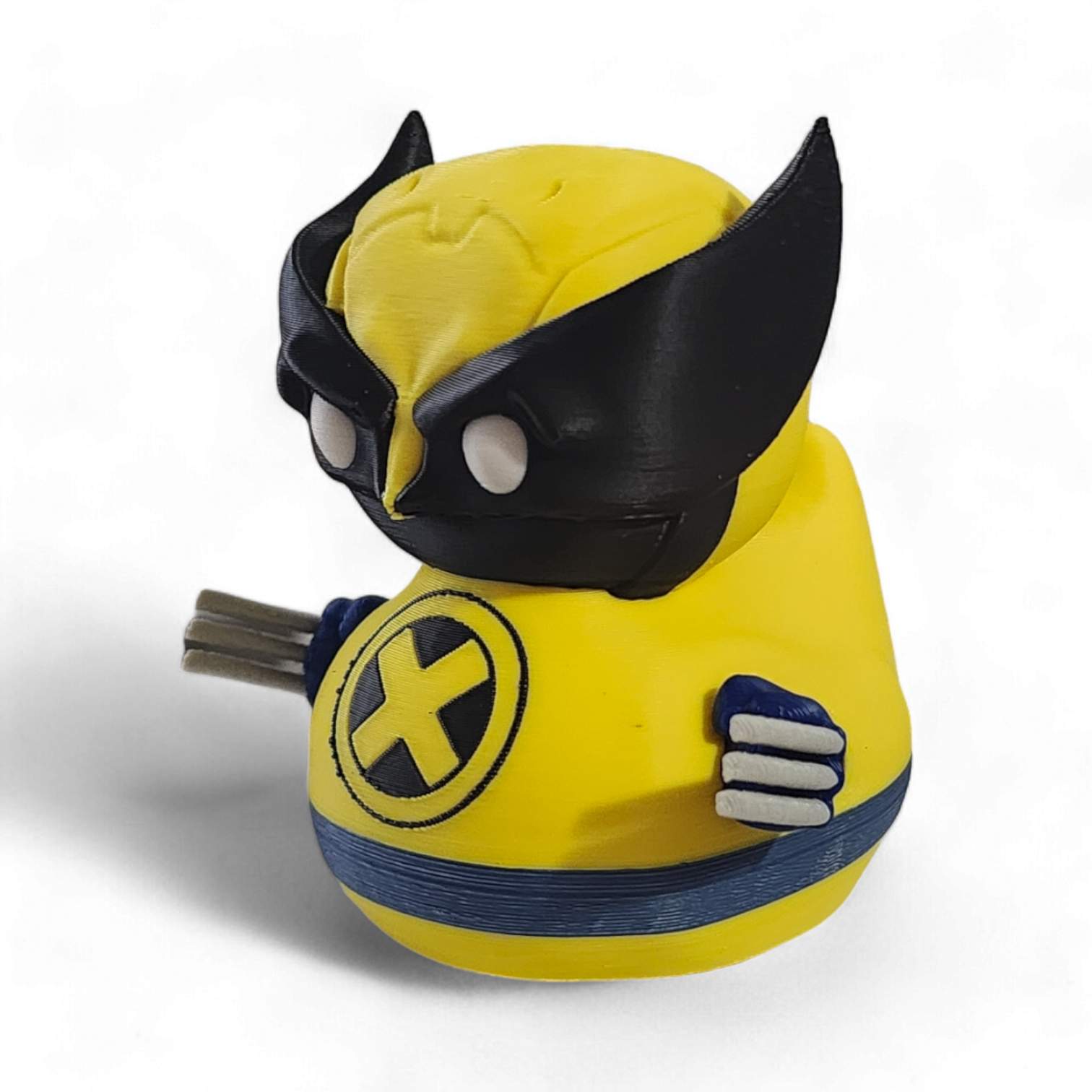 A small Wolverine figurine or toy in a bright yellow costume with black mask, blue accents, and white claws, photographed on a plain white background.