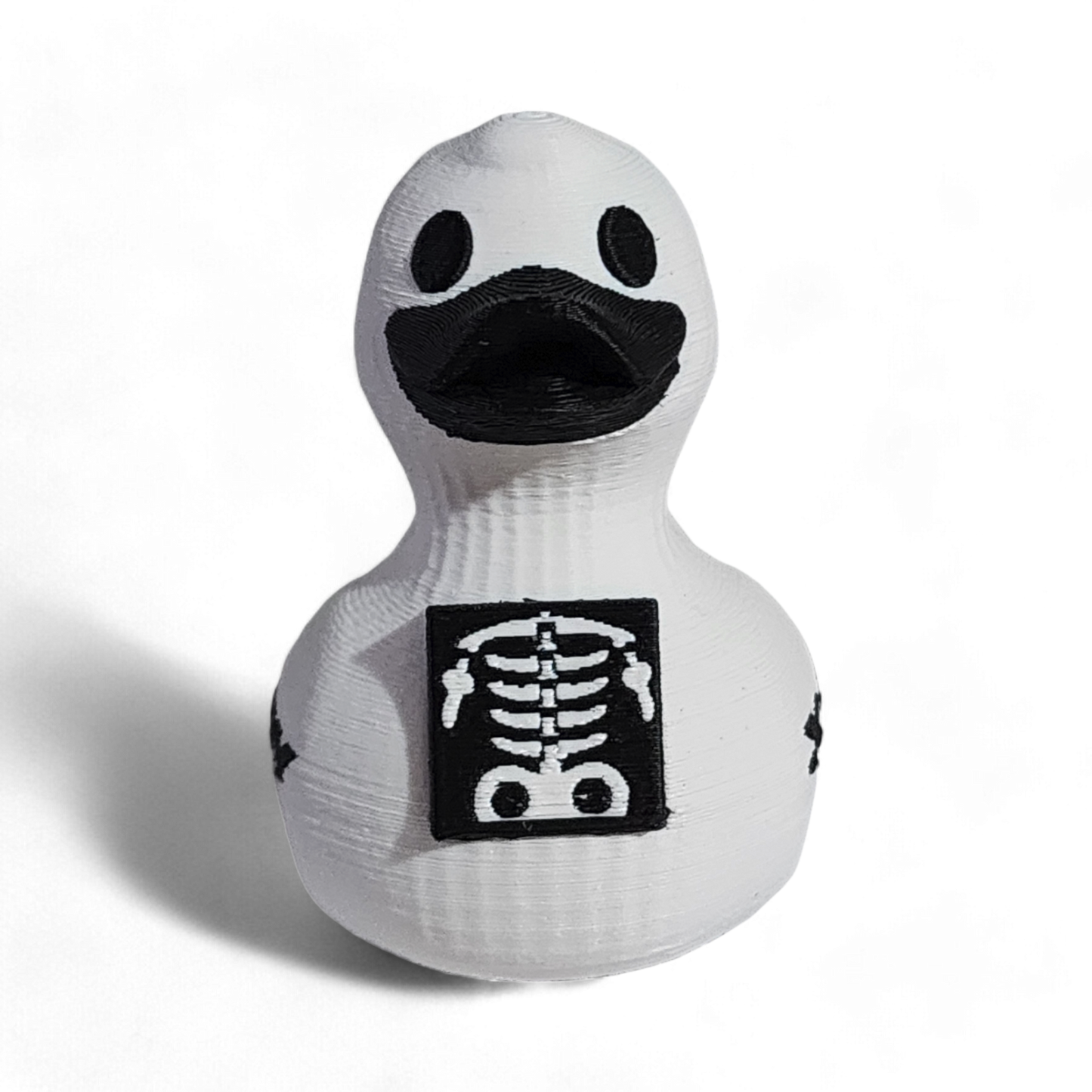 White 3D printed PLA duck with black skeleton design and 'X-Ray' text on a white background